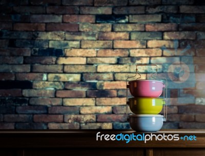 Colorful Tiffin Carrier On Wooden Cupboard With Blurred Vintage Stock Photo