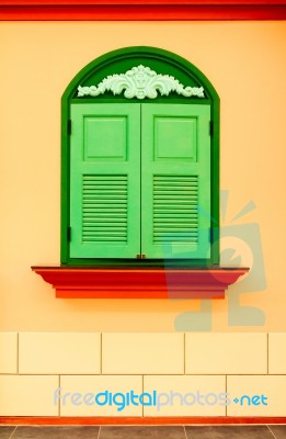 Colorful Wall With Green Window Stock Photo