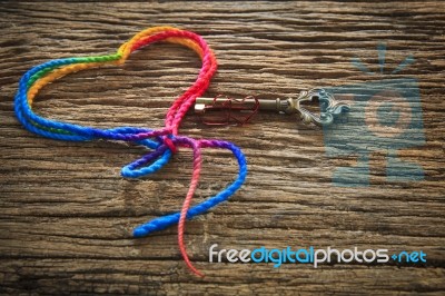 Colorful  Yarn Heart Shape And Key On Wood Textured Background U… Stock Photo