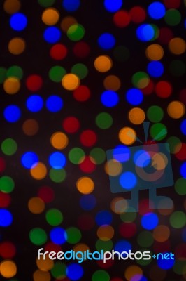 Colour Christmas Bokeh On A Dark Background Stock Photo