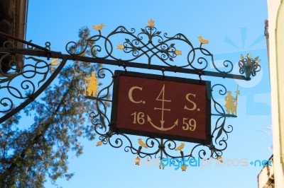 Colourful Hanging Sign In On A Building In Hallstatt Stock Photo