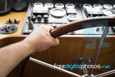 Commander Hands On The Boat Wheel Stock Photo