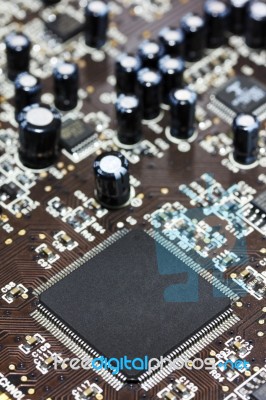 Computer Chip On Brown PCB  Stock Photo