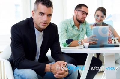 Confident Businessman In Office With His Team Stock Photo