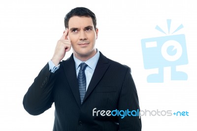 Confident Businessman Point Finger To Head Stock Photo