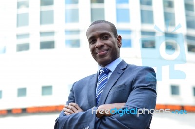 Confident Businessman With Arms Crossed Stock Photo