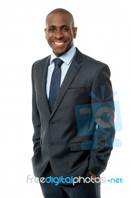 Confident Businessman With Hands In Pockets Stock Photo