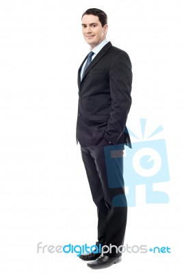 Confident Businessman With Hands In Pockets Stock Photo