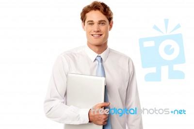 Confident Corporate Man Holding Laptop Stock Photo