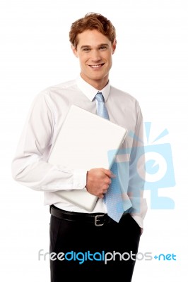 Confident Corporate Man Holding Laptop Stock Photo