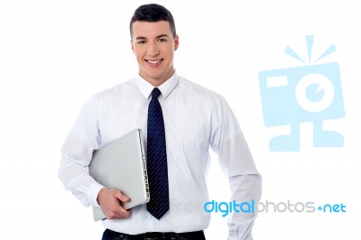 Confident Corporate Man Holding Laptop Stock Photo