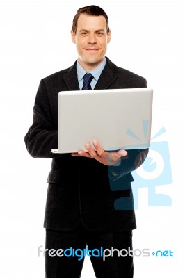 Confident Executive Using Laptop And Surfing Web Stock Photo