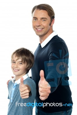 Confident Father And Son Duo Gesturing Thumbs Up Stock Photo