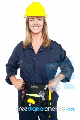 Confident Female Worker In Yellow Helmet Stock Photo