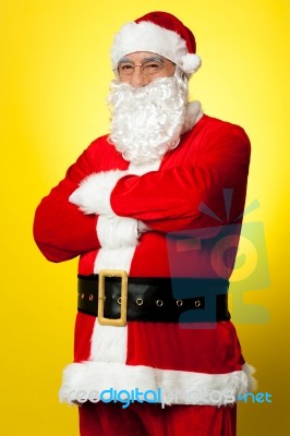 Confident Male Santa Posing With Arms Folded Stock Photo