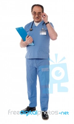 Confident Senior Doctor With File Stock Photo