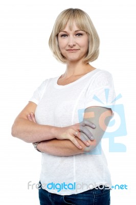 Confident Woman In Trendy Wear With Arms Folded Stock Photo