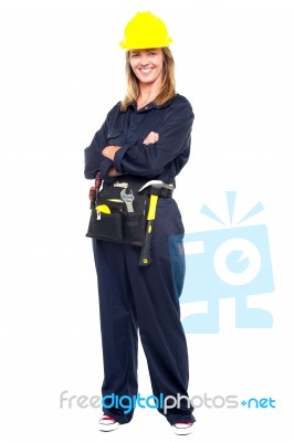 Confident Woman With Helmet And Belt Of Tools Stock Photo