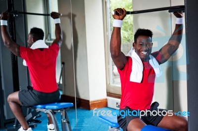 Confident Young African Guy Working Out In Gym Stock Photo