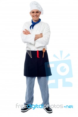 Confident Young Cook Posing In Uniform Stock Photo