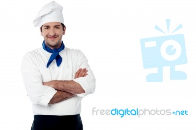 Confident Young Cook Posing In Uniform Stock Photo