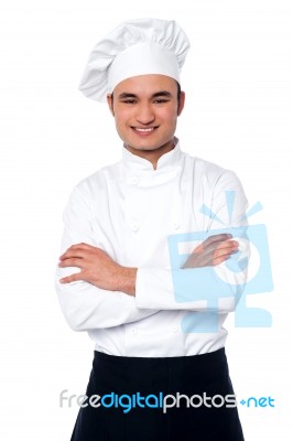 Confident Young Cook Posing In Uniform Stock Photo