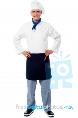 Confident Young Cook Posing In Uniform Stock Photo