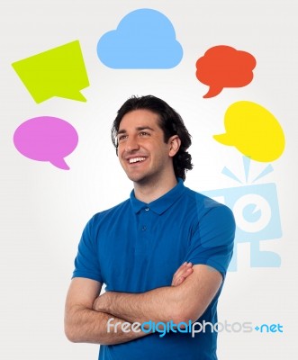 Confident Young Man With Speech Bubbles Stock Photo