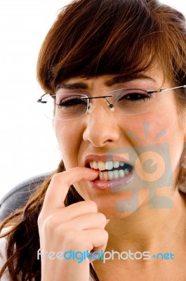 Confused Girl Biting Nail Stock Photo