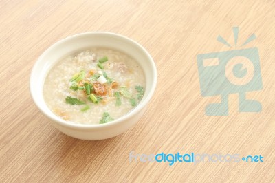 Congee Bowl On Wood Texture Tile Floor Stock Photo