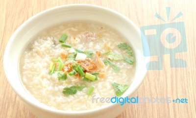 Congee Round Bowl On Wood Texture Tile Floor Stock Photo