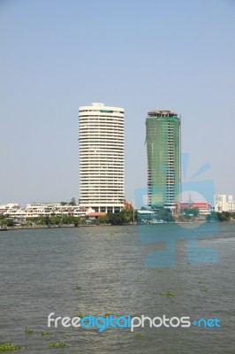 Construction And Completed Building On The River Bank Stock Photo