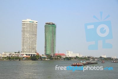 Construction And Completed Building On The River Bank Stock Photo