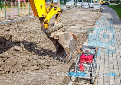 Construction Of A New Road. Excavator Prepares The Surface Stock Photo
