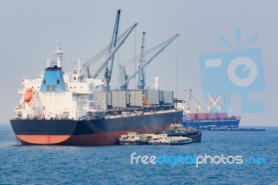 Container Boat Loading Goods Over Clear Blue Water Sea Use For Vessel ,nautical Transportation And Ocean Logistic Industry Stock Photo