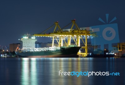 Container Cargo Freight Ship With Working Cranes Stock Photo