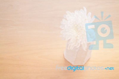 Contemporary Wooden Table With White Flower Stock Photo