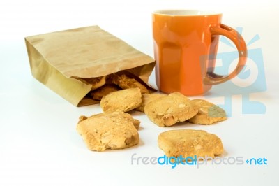 Cookies In Paper Bag And A Cup Of Coffee Stock Photo