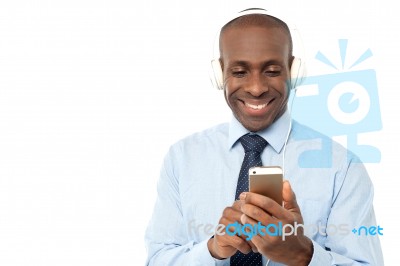 Cool Young Businessman Enjoying Music Stock Photo