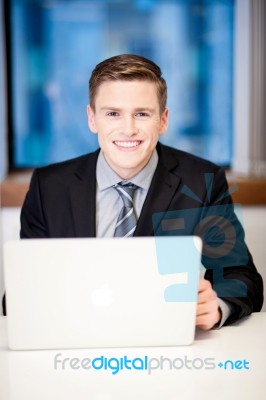 Corporate Guy Browsing In His Laptop Stock Photo