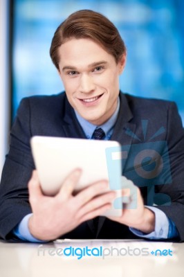 Corporate Guy Browsing On Tablet Pc Stock Photo