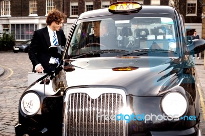 Corporate Guy Interacting With Taxi Driver Stock Photo