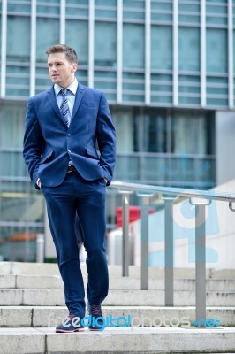 Corporate Guy Walking Down The Stairs Stock Photo