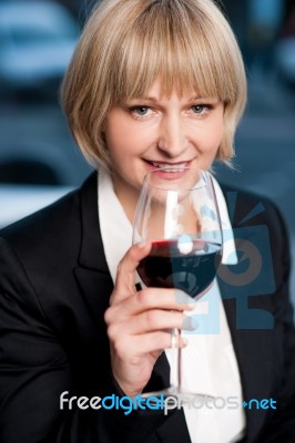 Corporate Lady Drinking Red Wine Stock Photo