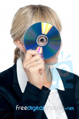 Corporate Lady Looking Through Compact Disc Hole Stock Photo