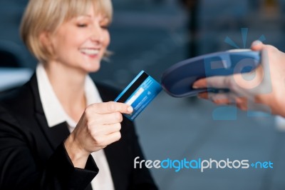 Corporate Lady Swiping Her Card To Pay Stock Photo