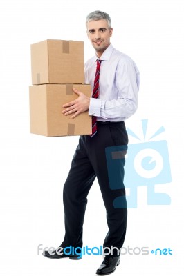 Corporate Man Holding Stack Of Parcel Boxes Stock Photo