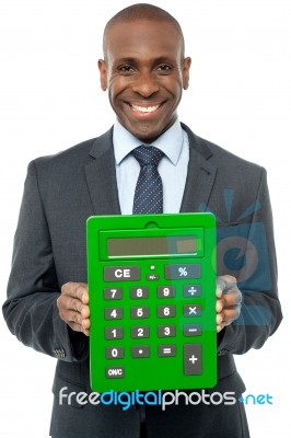 Corporate Man Showing Big Green Calculator Stock Photo