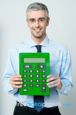 Corporate Man Showing Calculator Stock Photo