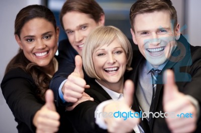 Corporate Team Gesturing Thumbs Up Stock Photo